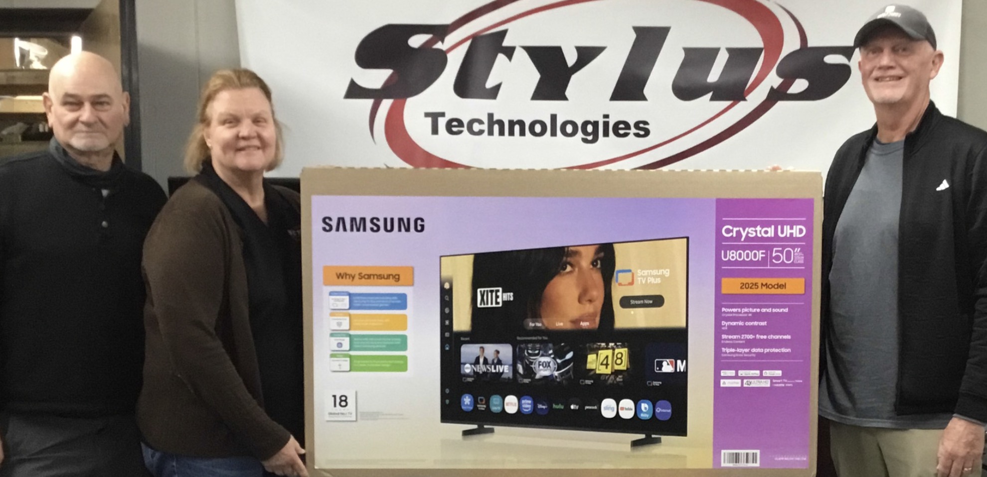 Stylus Technologies retail team with a new Samsung Crystal UHD TV in the Bluffton showroom